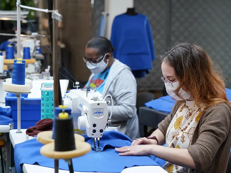 Two women working on JUKI machines